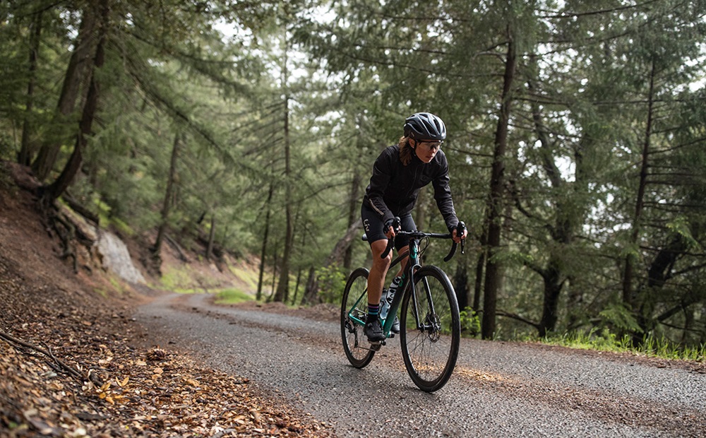 A woman on her bike enjoying an open road.